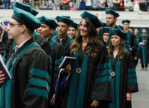 doctor of physical therapy graduates walk in commencement ceremony